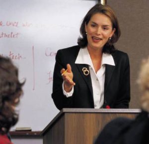 Business woman speaking to one person in the group